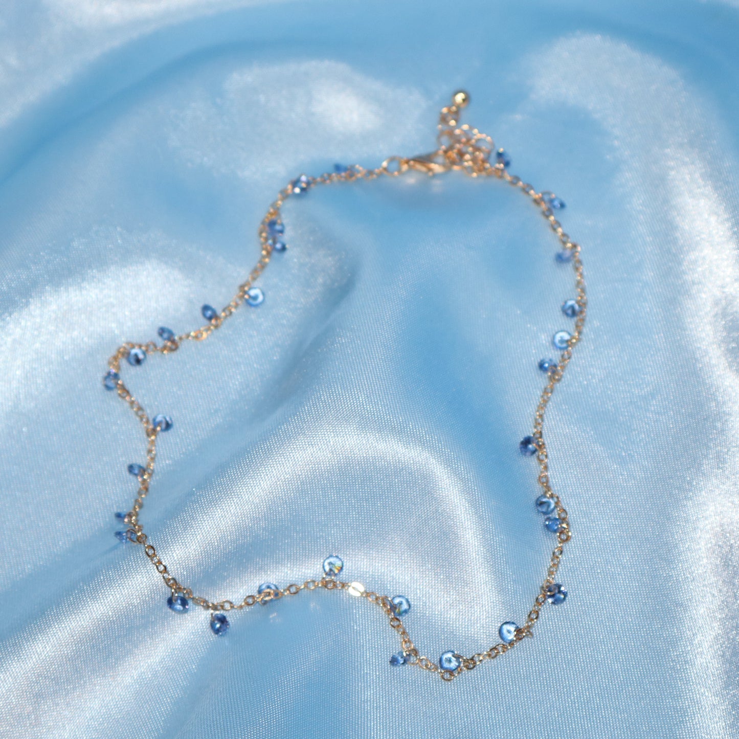 Light blue stone, gold necklace