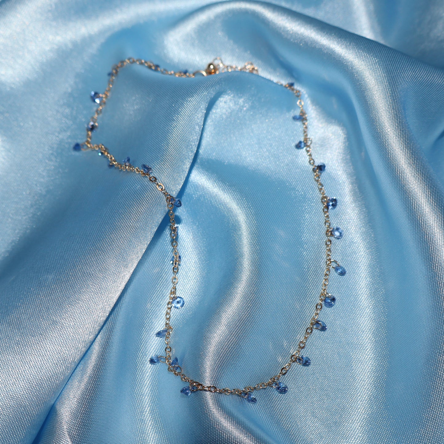 Light blue stone, gold necklace