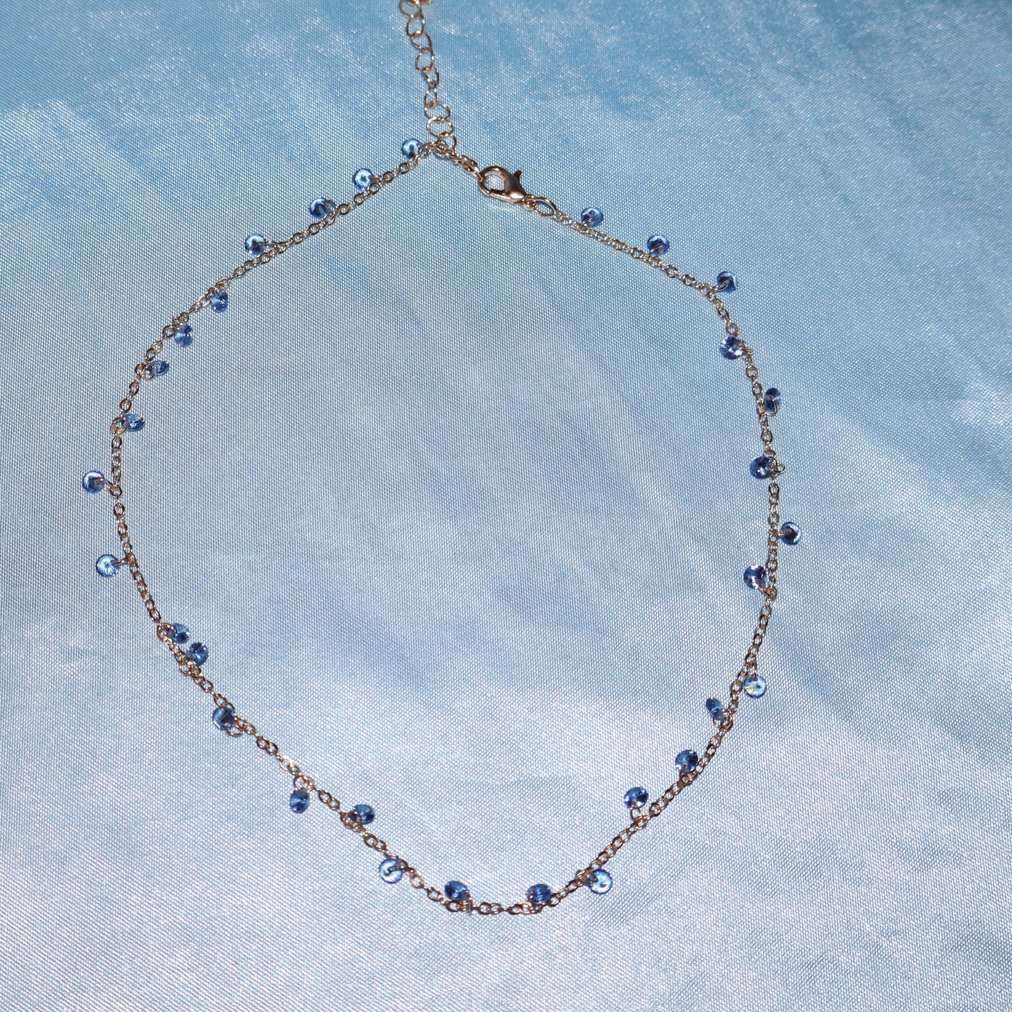 Light blue stone, gold necklace