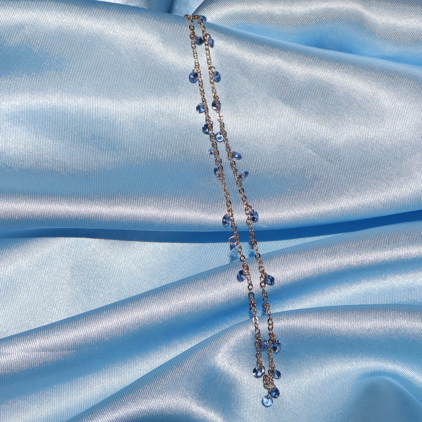 Light blue stone, gold necklace