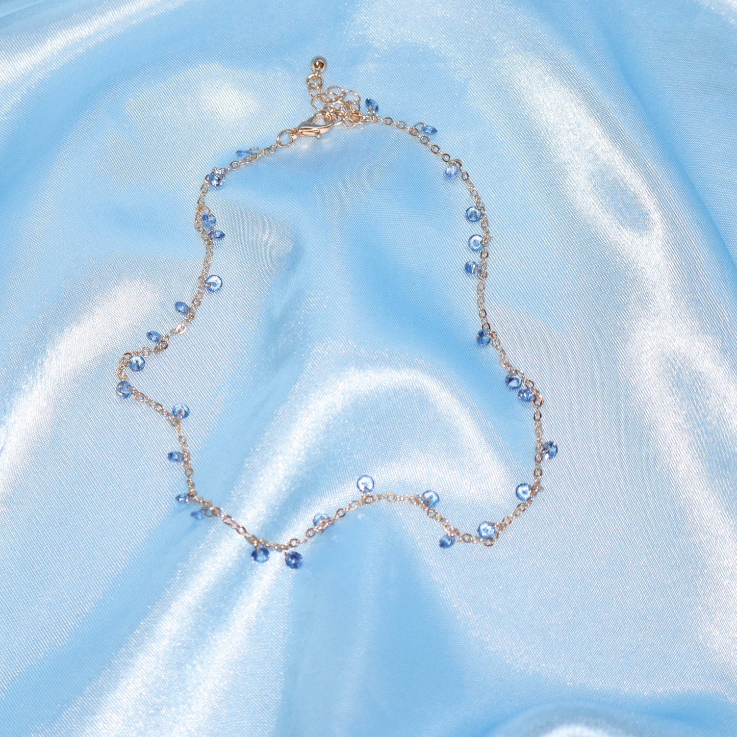 Light blue stone, gold necklace