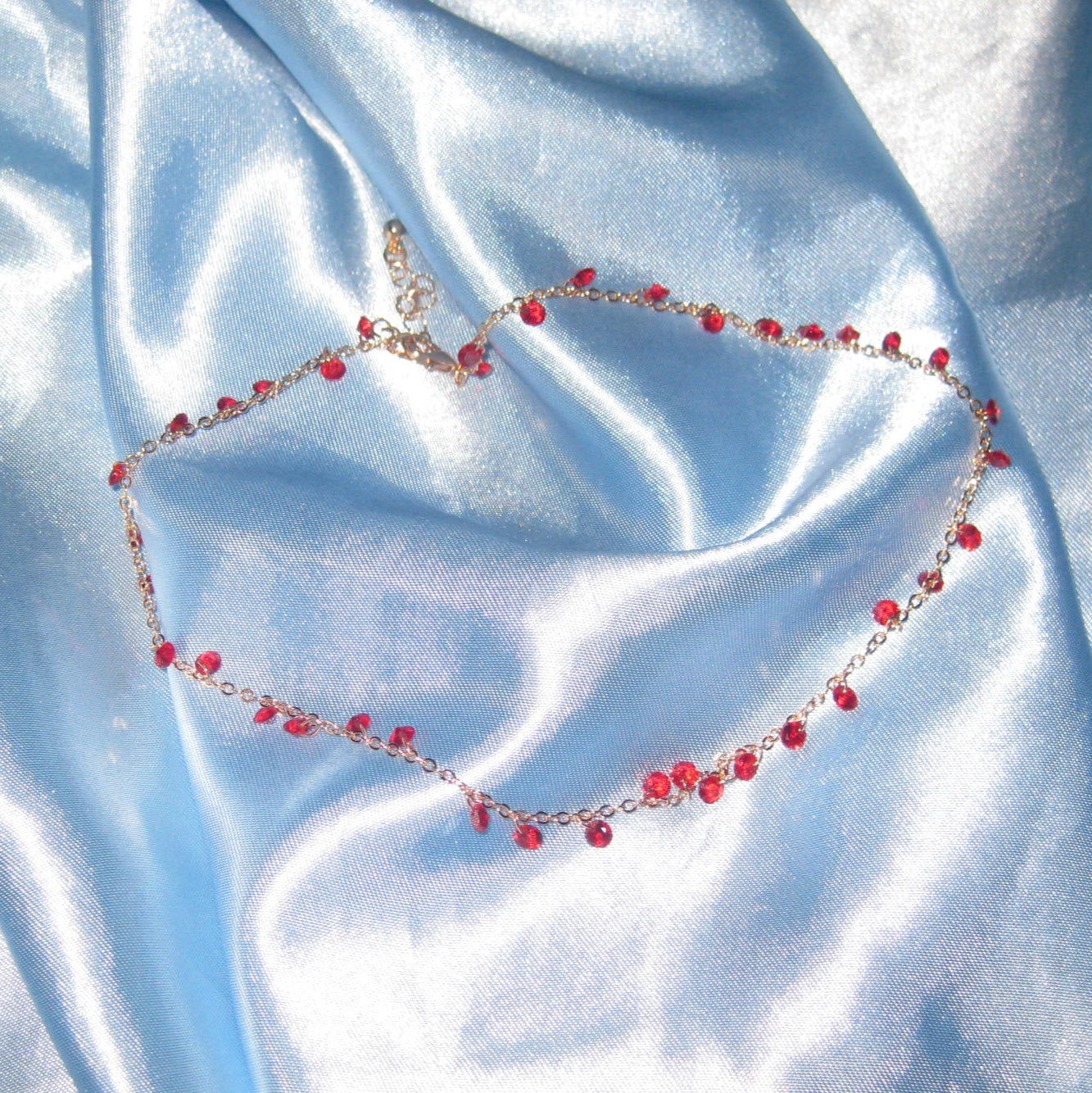 red gem gold necklace