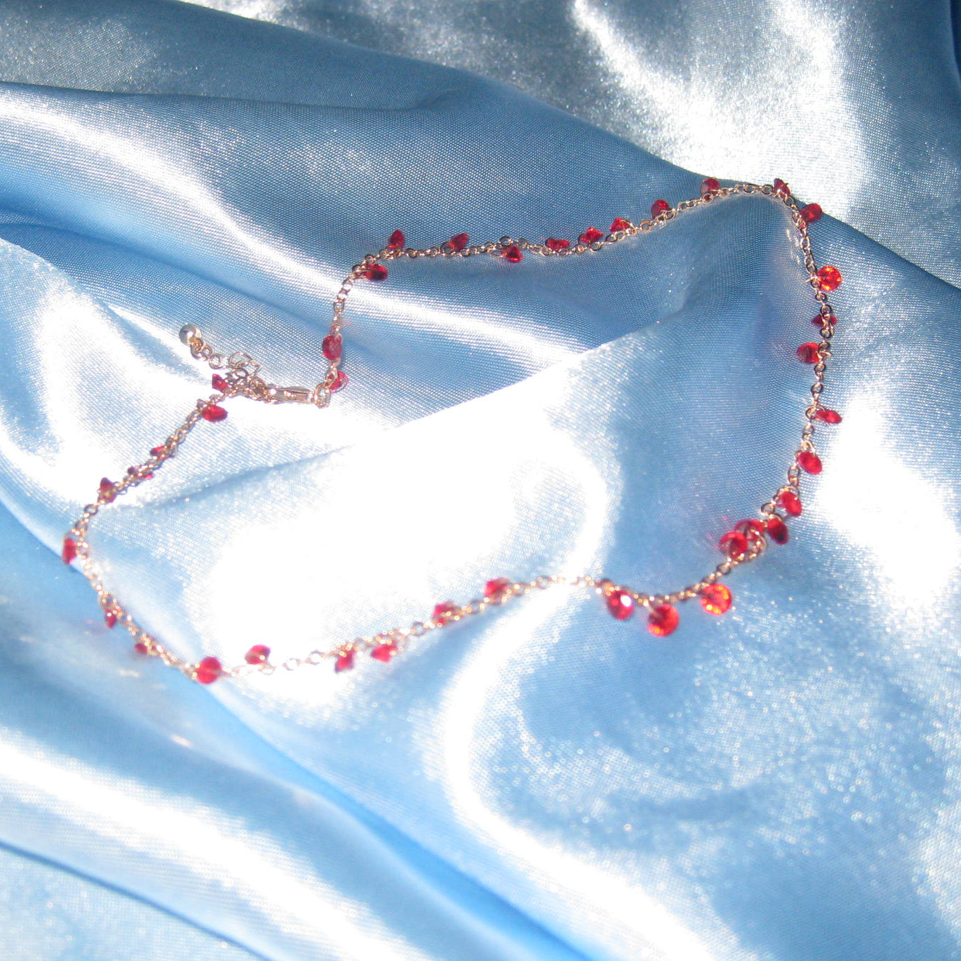 red gem gold necklace