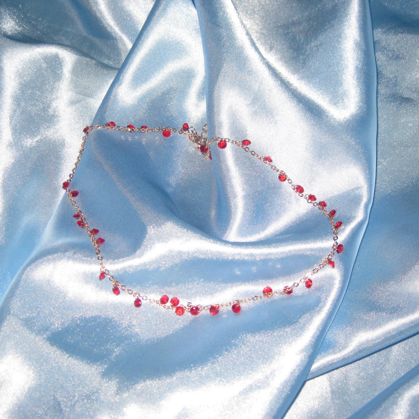 red gem gold necklace
