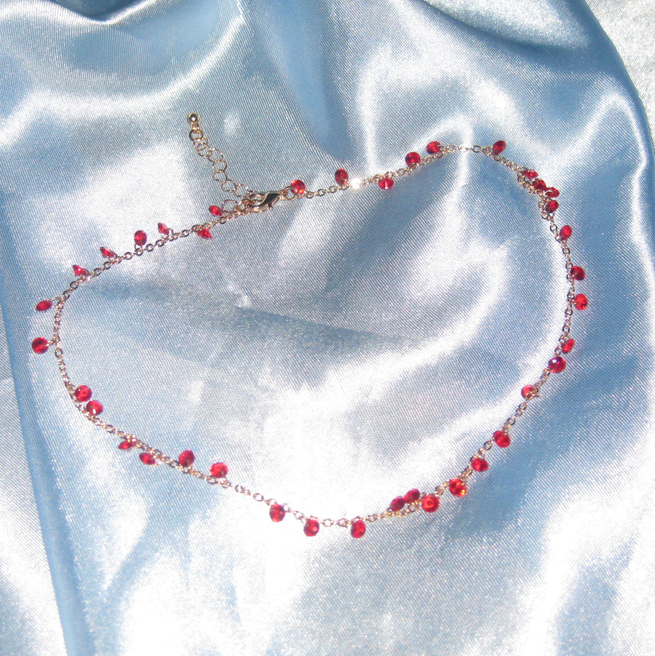 red gem gold necklace