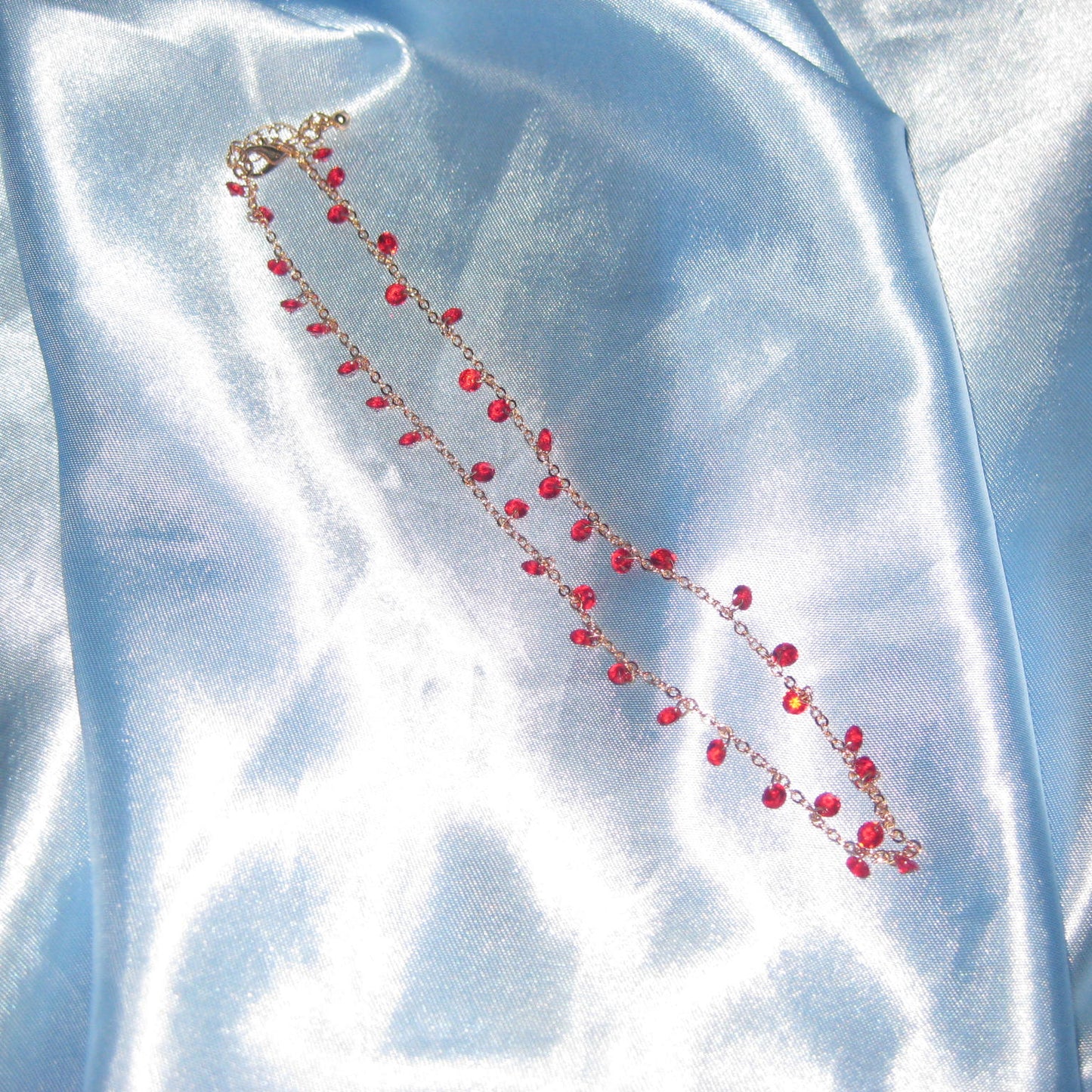 red gem gold necklace