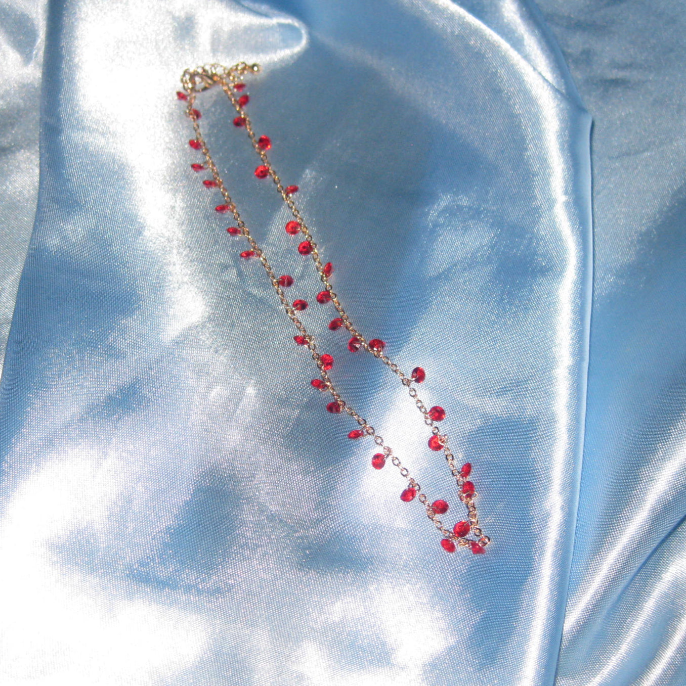 red gem gold necklace