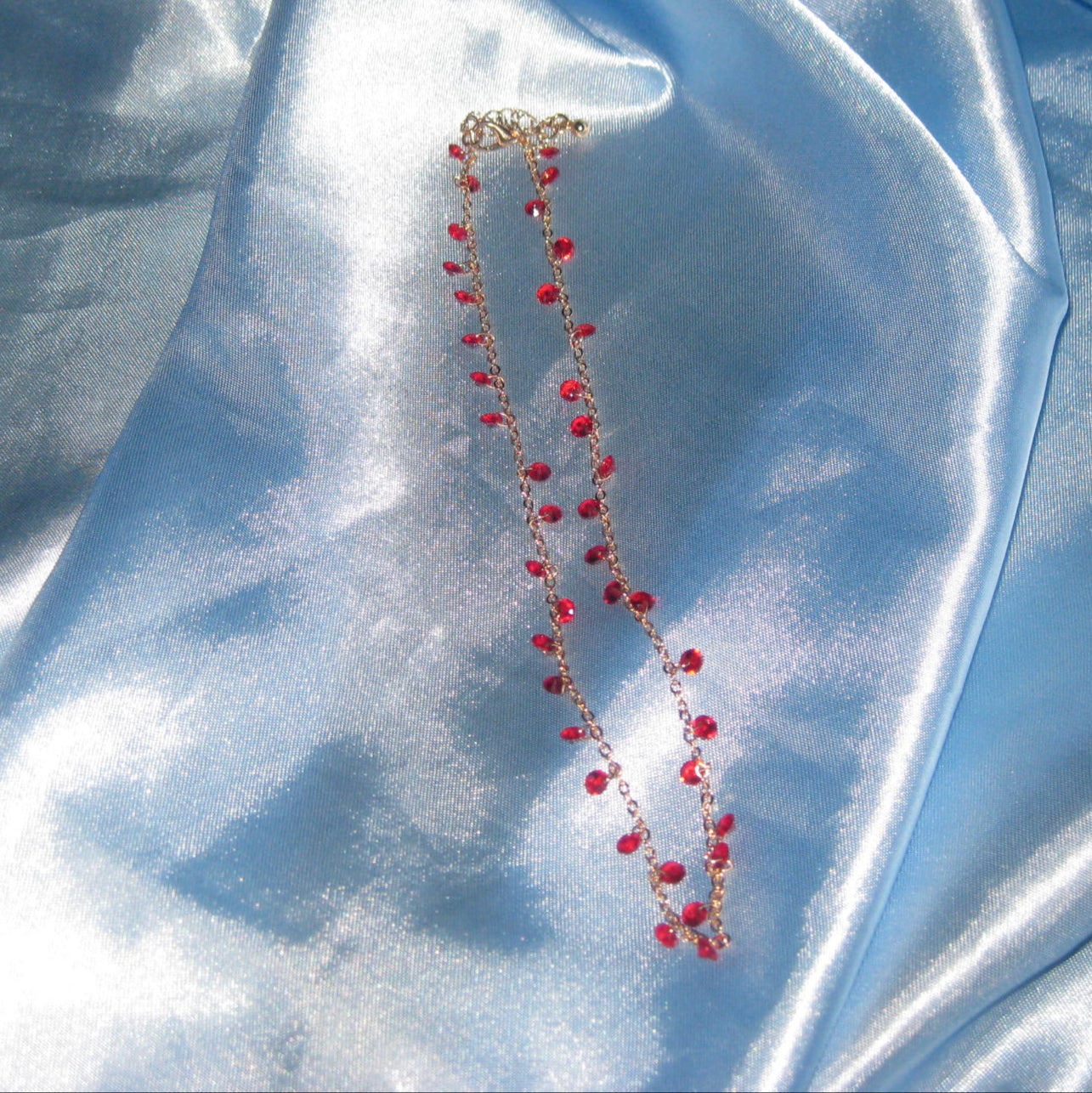 red gem gold necklace