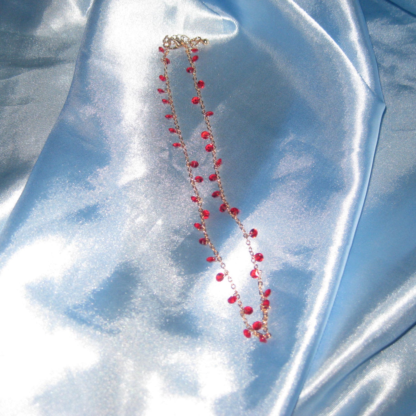 red gem gold necklace