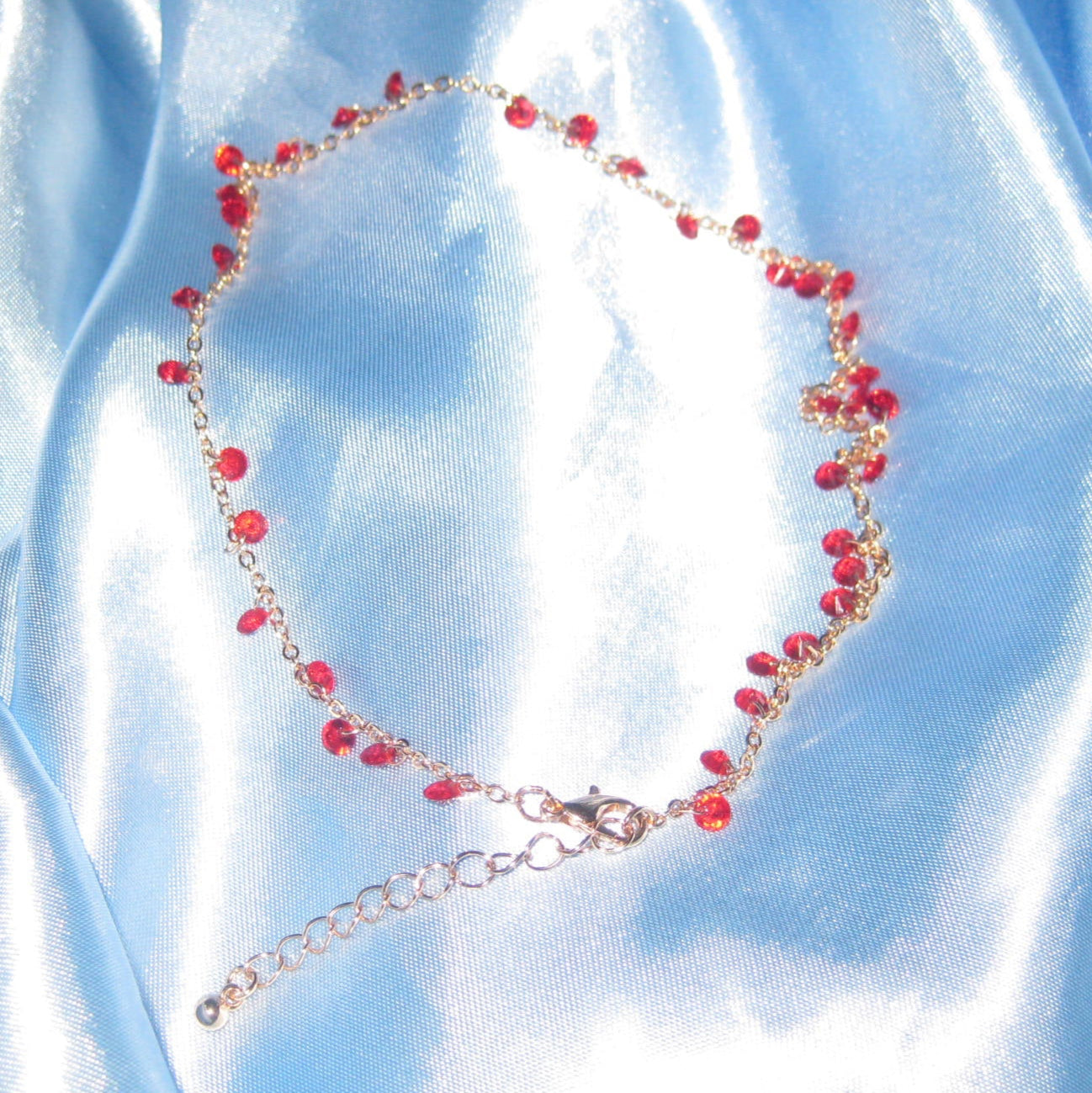 red gem gold necklace