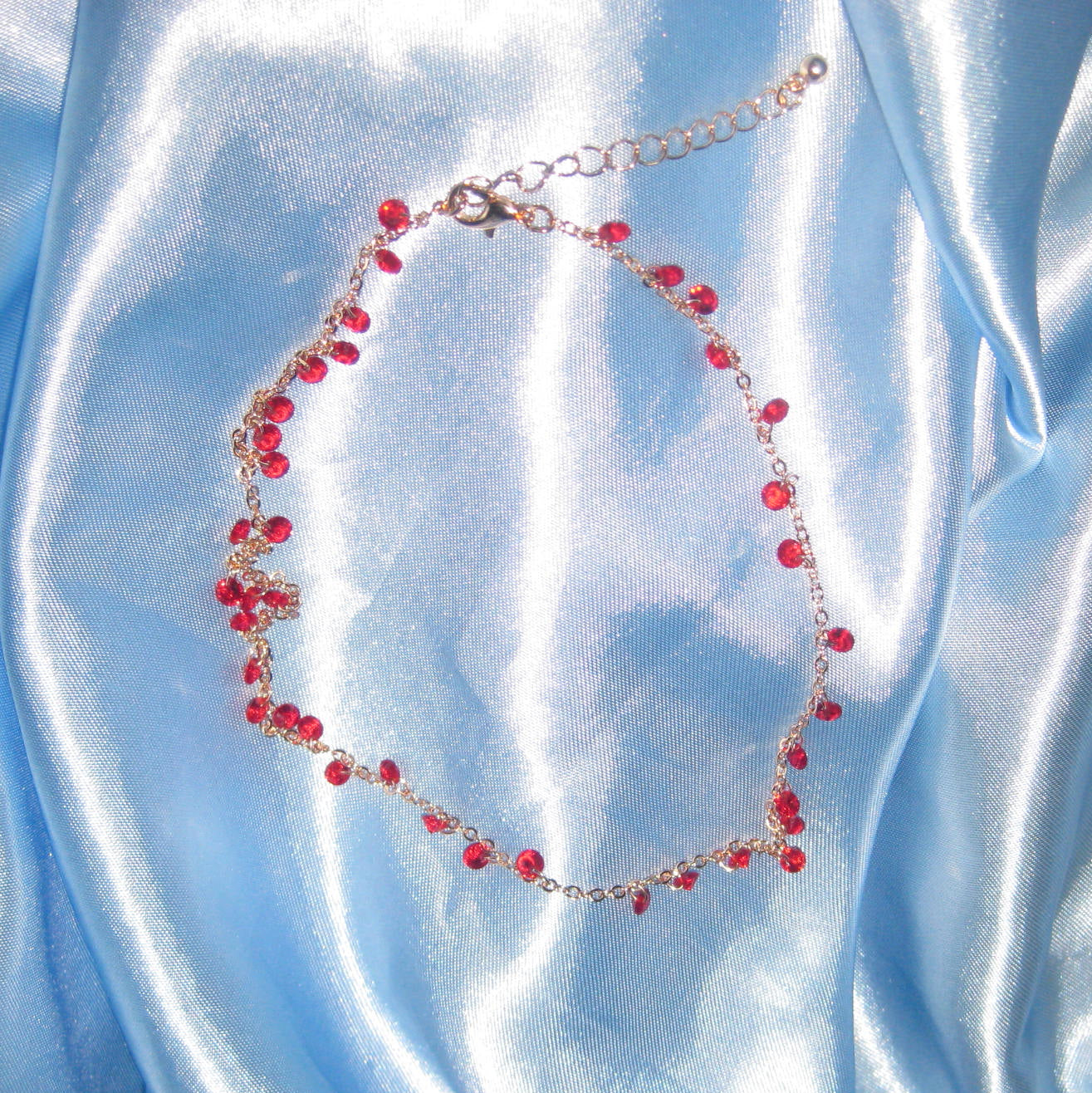 red gem gold necklace