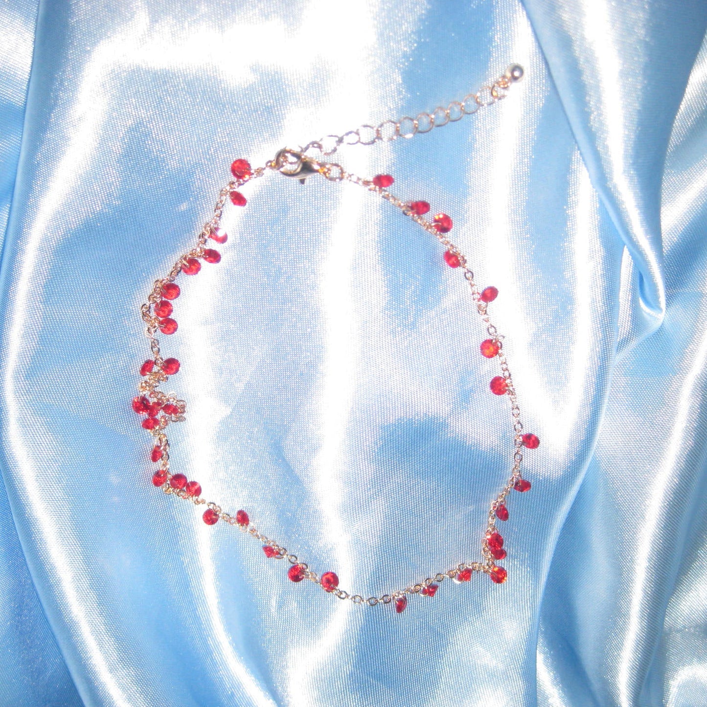 red gem gold necklace