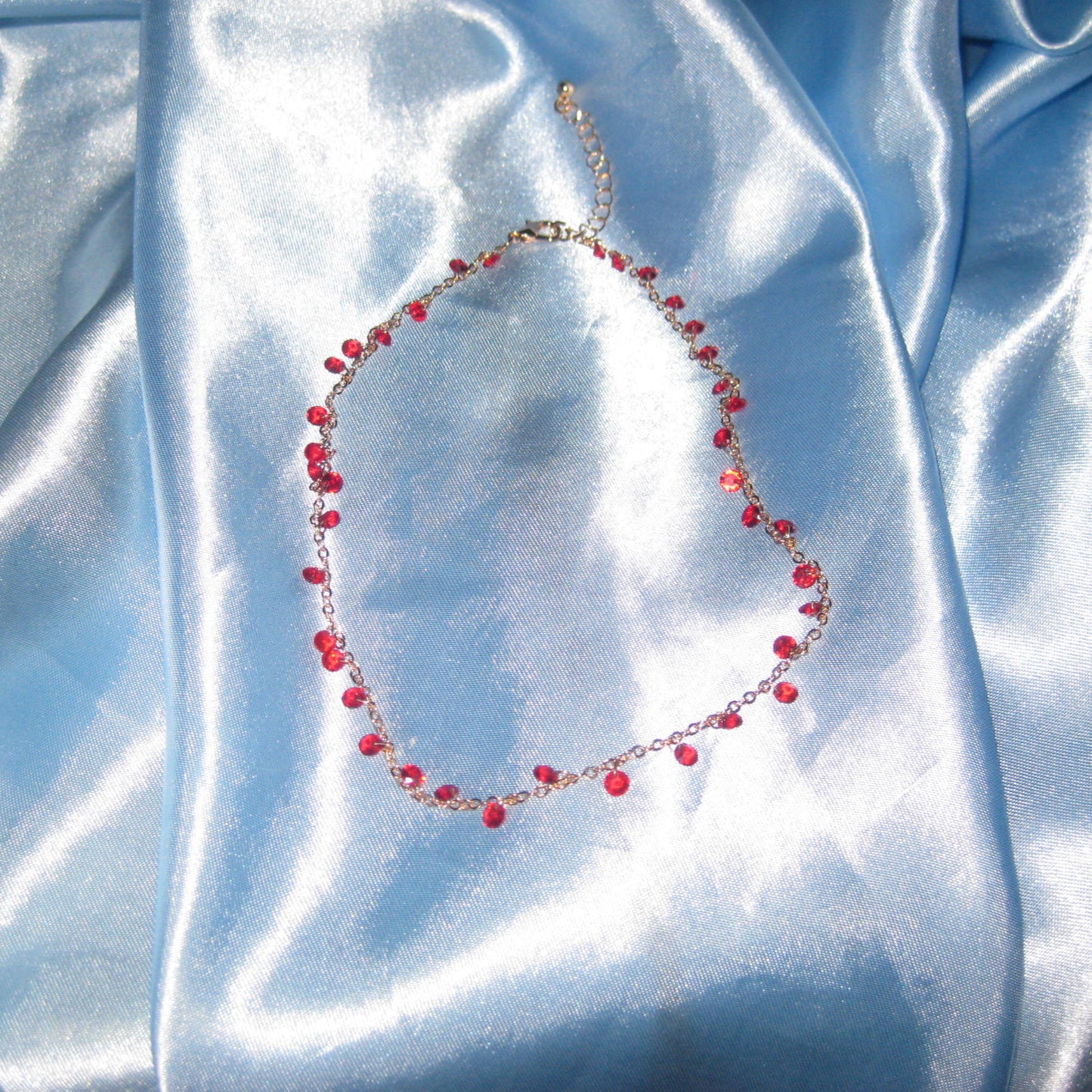 red gem gold necklace