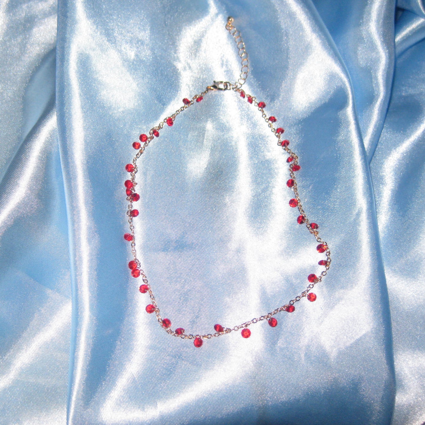 red gem gold necklace