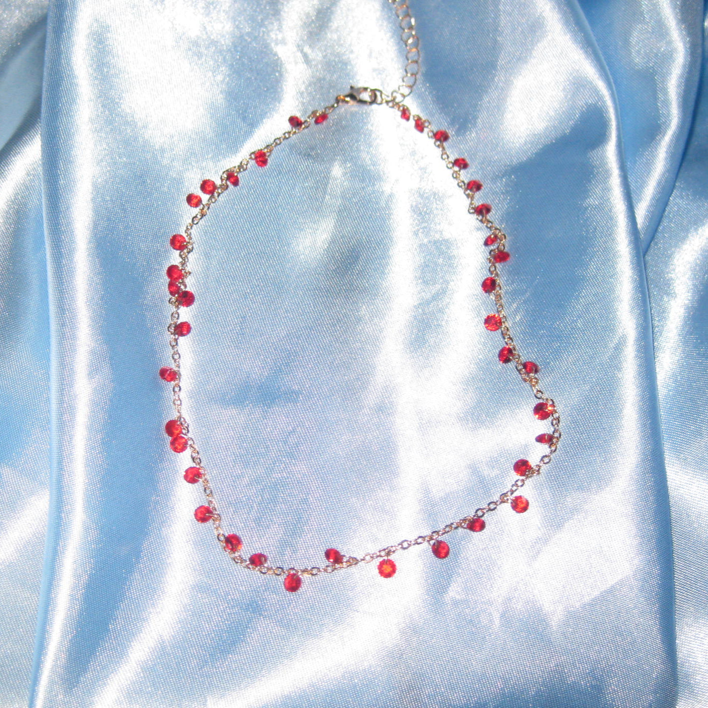 red gem gold necklace