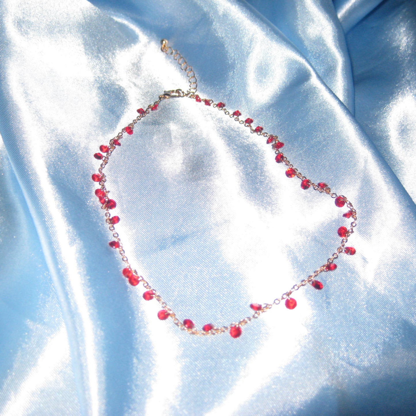 red gem gold necklace