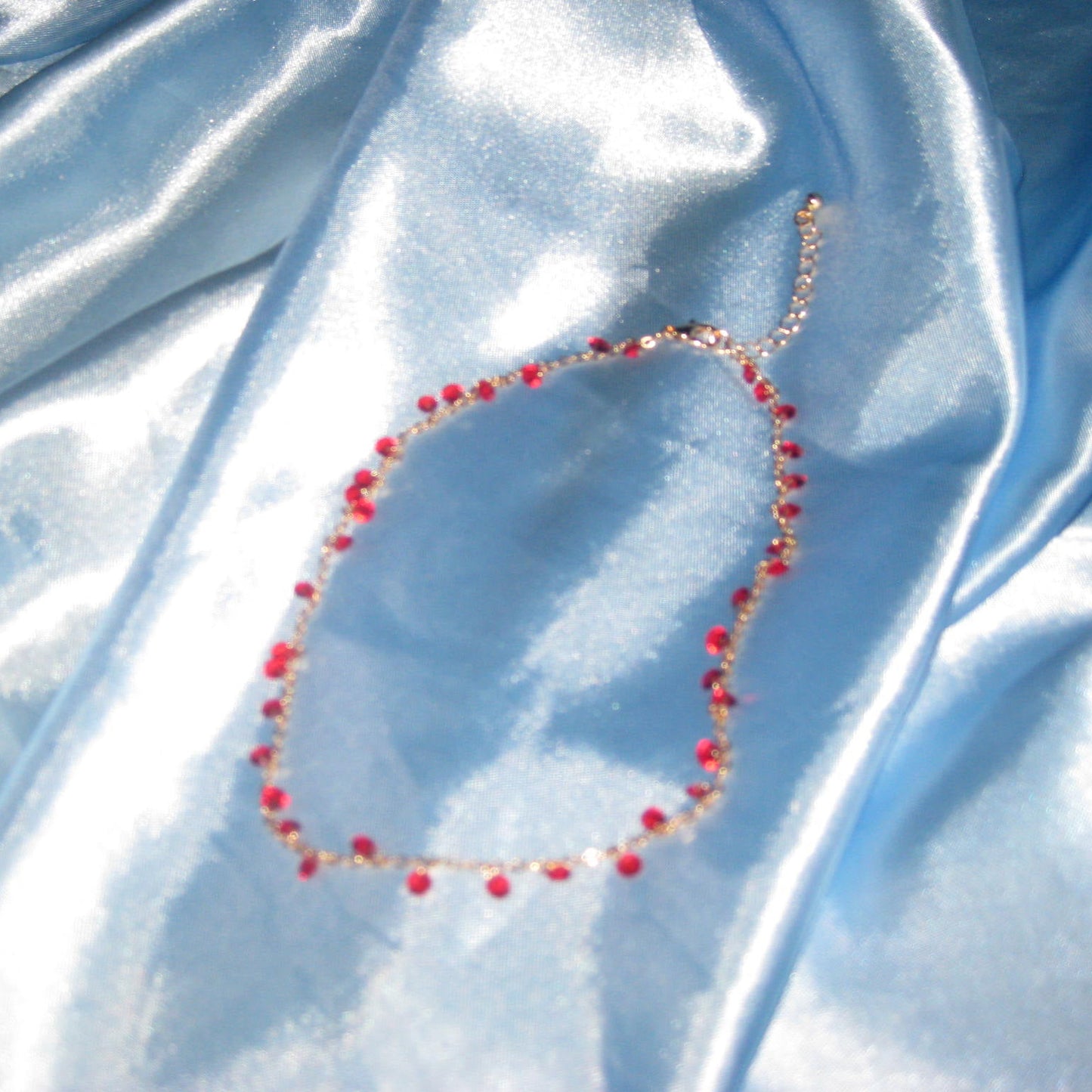 red gem gold necklace