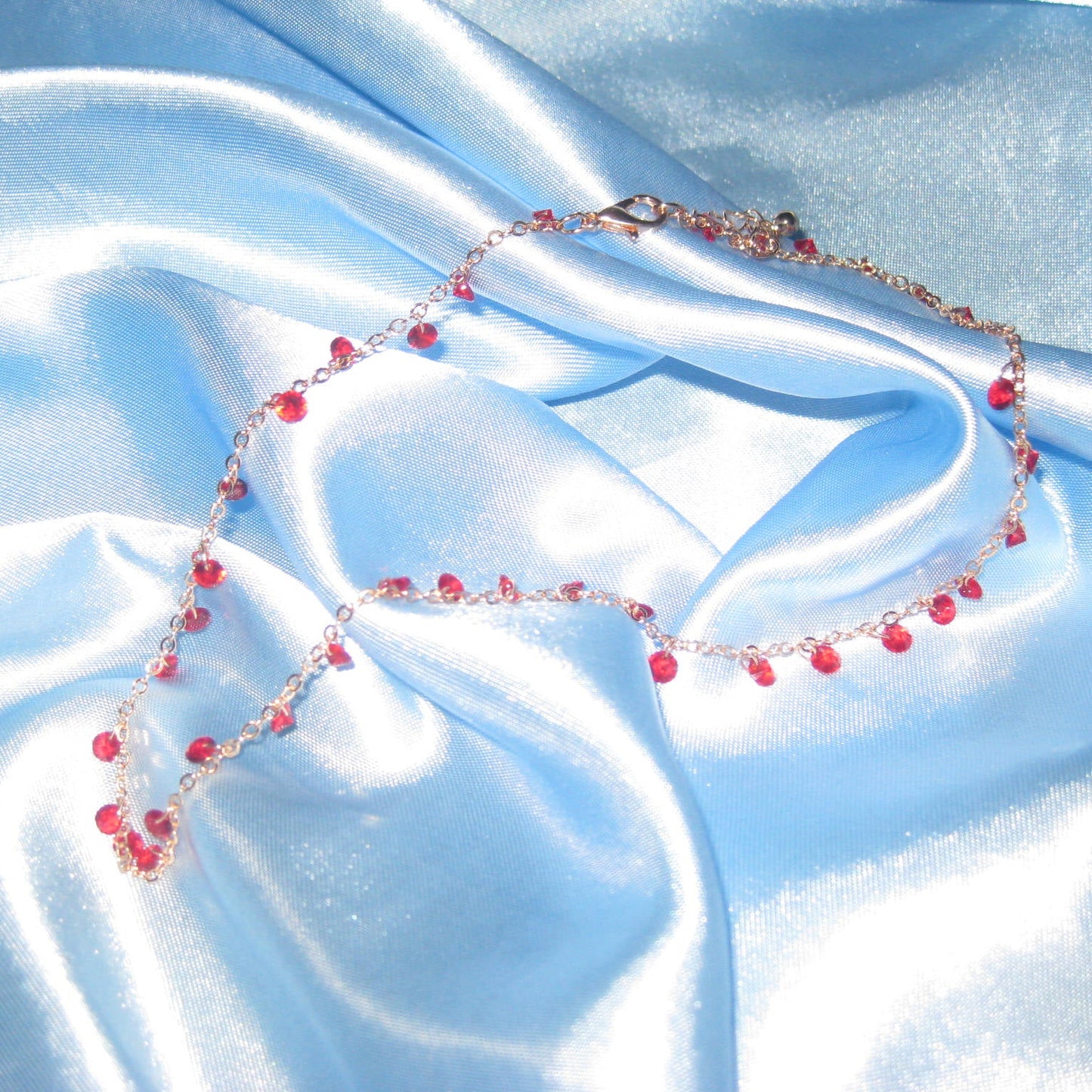red gem gold necklace