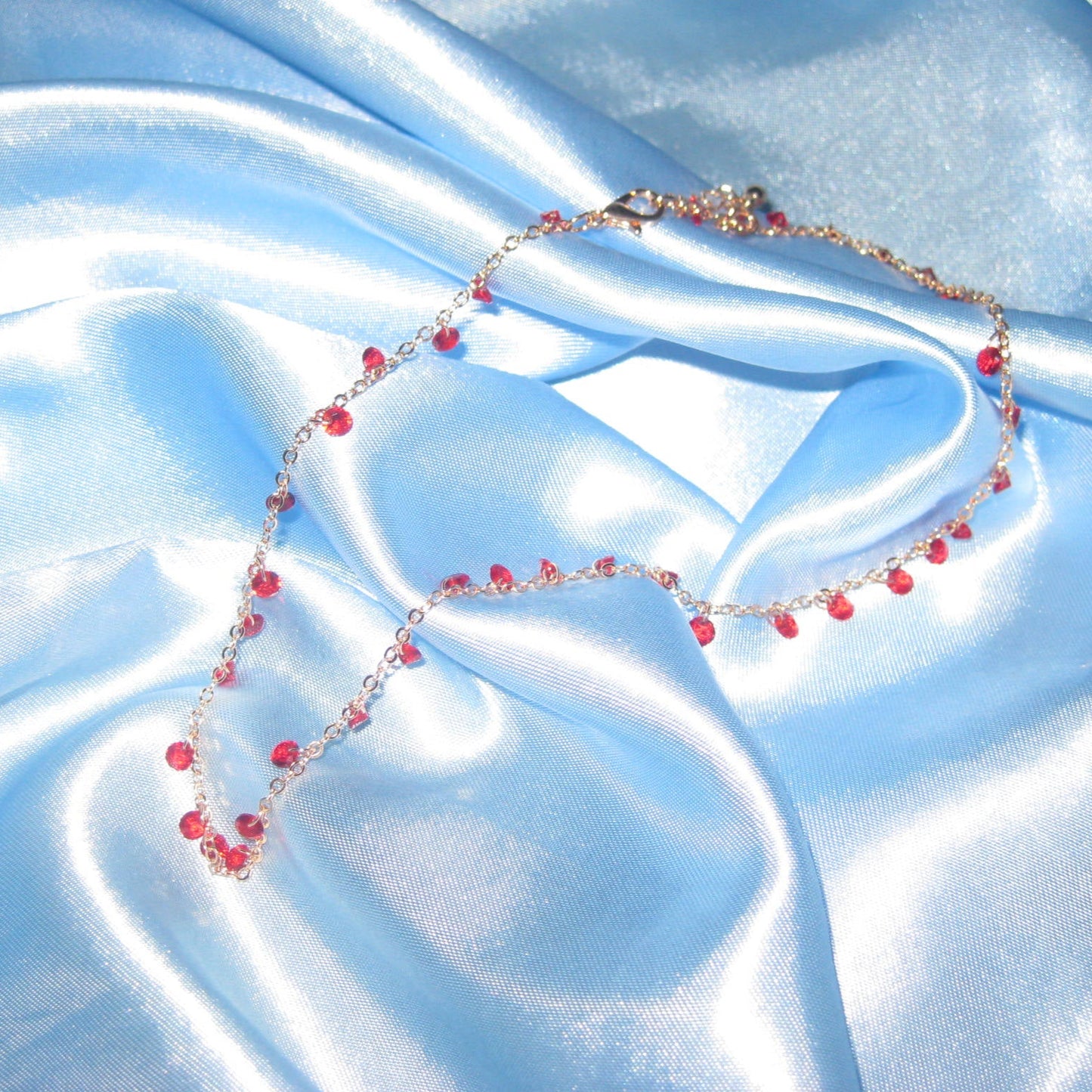 red gem gold necklace