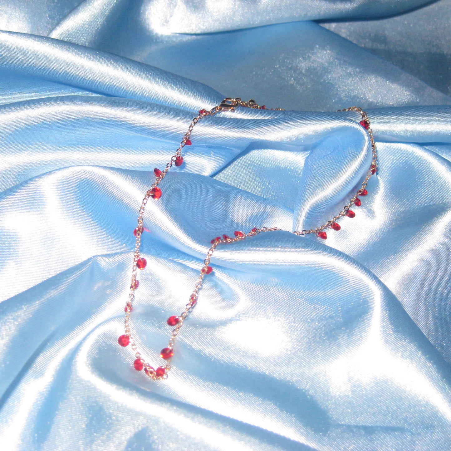 red gem gold necklace