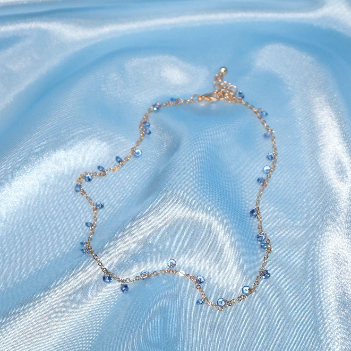 Light blue stone, gold necklace