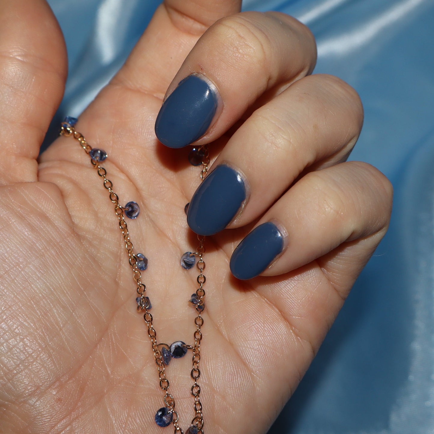 Light blue stone, gold necklace