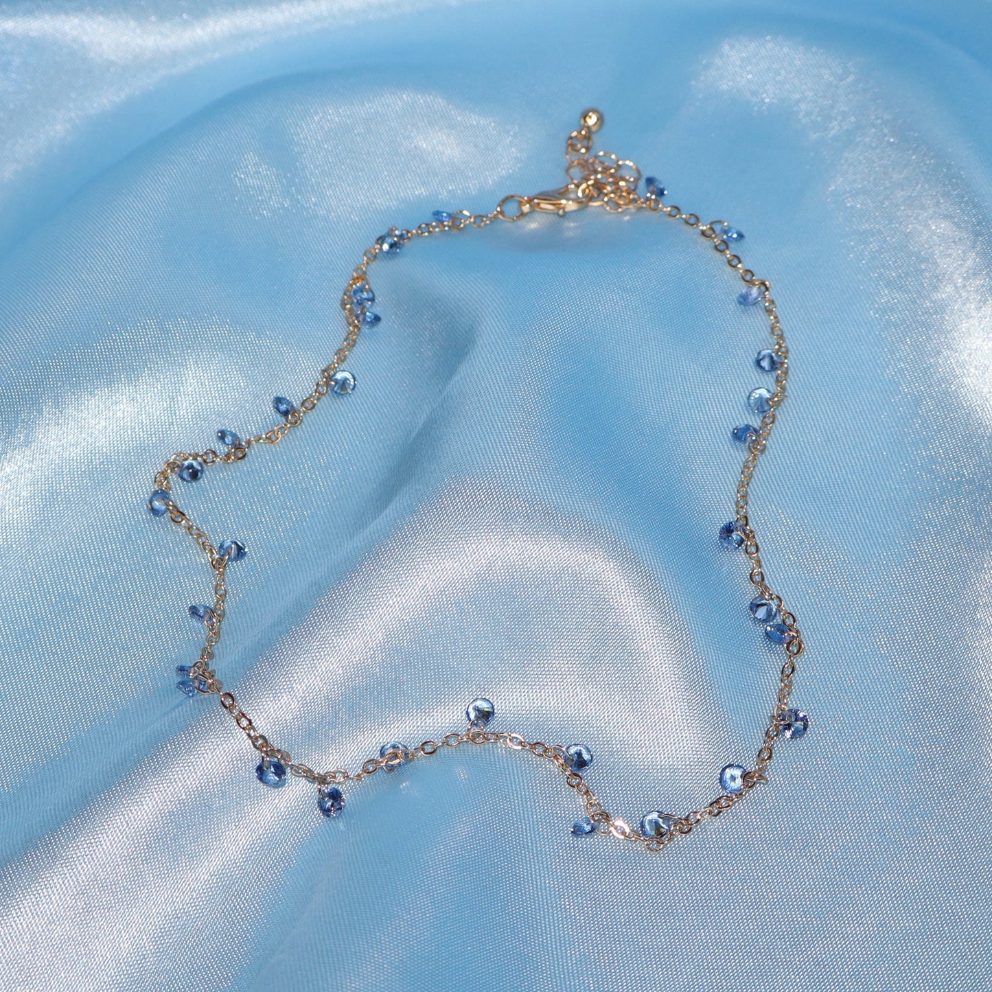 Light blue stone, gold necklace