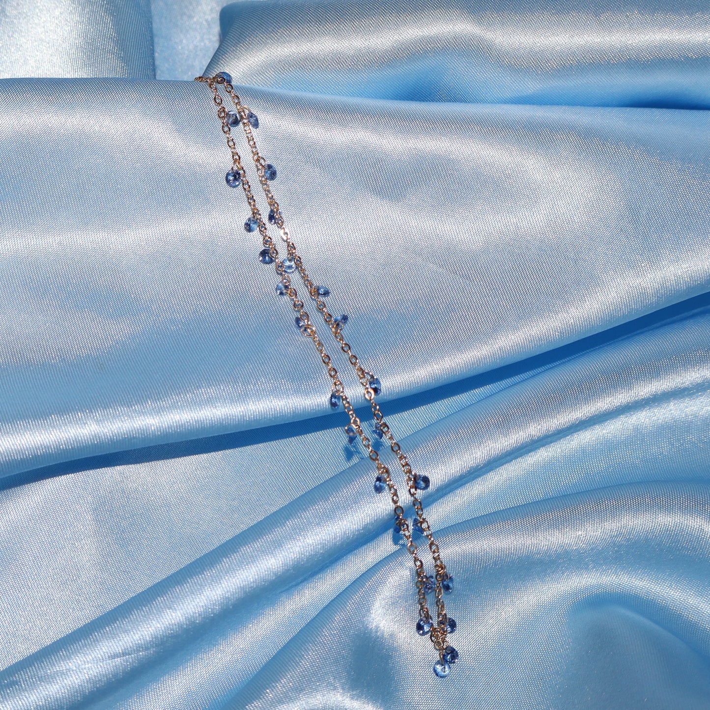Light blue stone, gold necklace