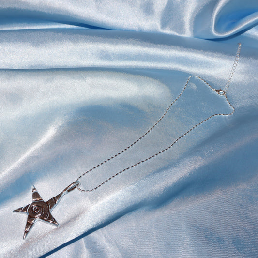 Star pendant, with a swirl design, silver chain necklace.