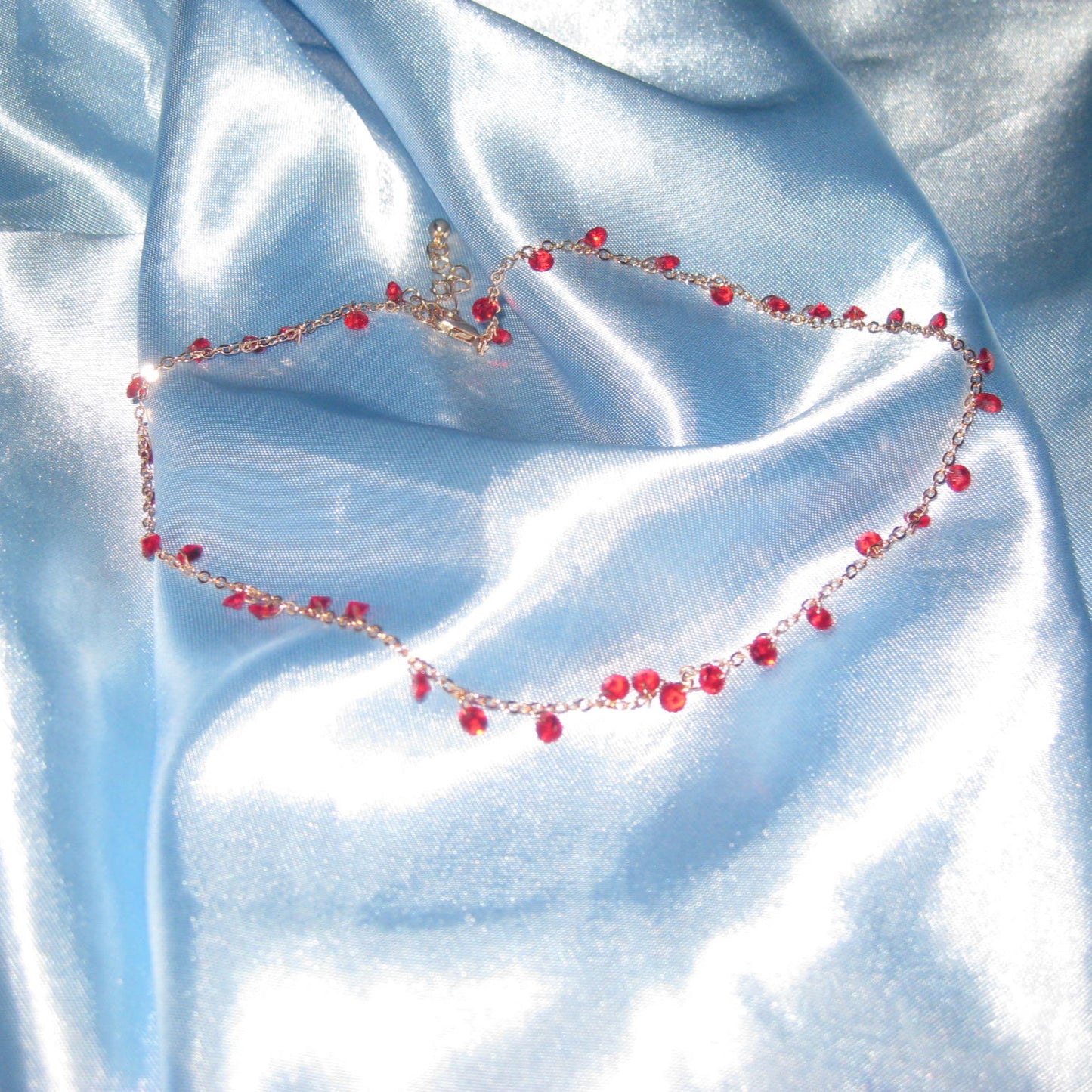 red gem gold necklace