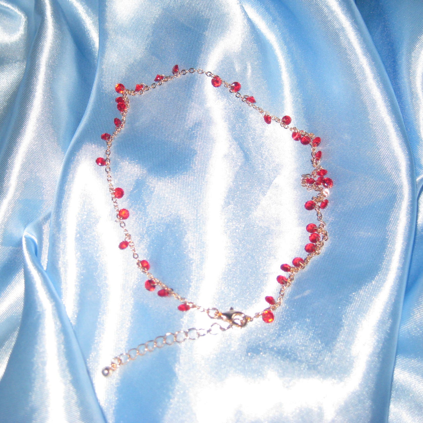 red gem gold necklace