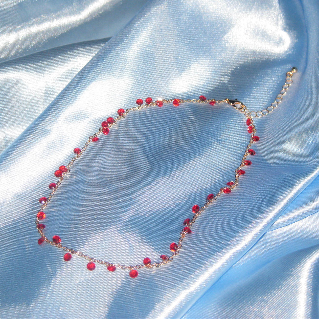 red gem gold necklace
