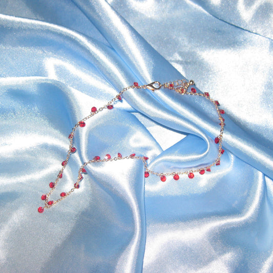 red gem gold necklace